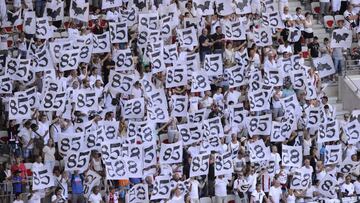 People stand in the grandstands as they hold white placards in tribute to the victims of the Bastille day attack in Nice before the French L1 football match between OGC Nice and Rennes on August 14, 2016, at the Allianz Riviera stadium in Nice, southern France. / AFP PHOTO / Franck PENNANT