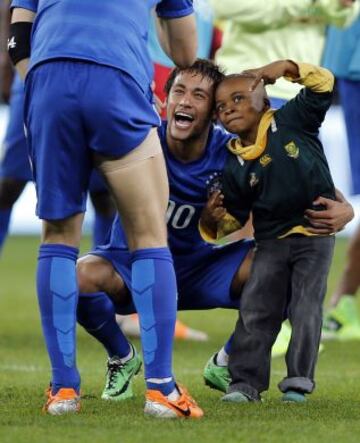 Un niño sudafricano que invadió el terreno de juego acabo bromeando con el delantero brasileño Neymar al final de un partido de fútbol amistoso entre Sudáfrica y Brasil en el estadio Soccer City de Soweto.