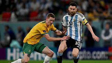 Argentina's forward #10 Lionel Messi is challenged by Australia's defender #04 Kye Rowles during the Qatar 2022 World Cup round of 16 football match between Argentina and Australia at the Ahmad Bin Ali Stadium in Al-Rayyan, west of Doha on December 3, 2022. (Photo by MANAN VATSYAYANA / AFP) (Photo by MANAN VATSYAYANA/AFP via Getty Images)