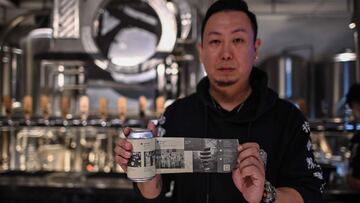 This photo taken on November 20, 2020 shows Wang Fan, founder of the No. 18 Brewery, posing with one of his beers with images of the city&#039;s fight against the Covid-19 coronavirus in Wuhan, China&#039;s central Hubei province. - When the coronavirus e