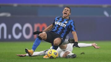 02 February 2021, Italy, Milan: Inter Milan&#039;s Alexis Sanchez is brought down by Juventus&#039; Merit Demiral during the Coppa Italia semi-final first leg soccer match between Inter Milan and Juventus at the Giuseppe Meazza stadium. Photo: Jonathan Mo