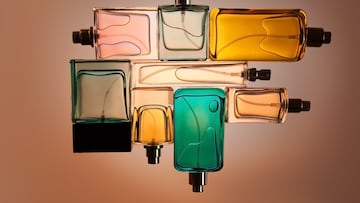 Top view, flat lay of a set of perfume bottles on a beige blank background