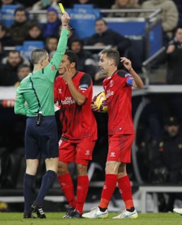 El árbitro Iglesias Villanueva muestra la cartulina amarilla a Fernando Navarro.