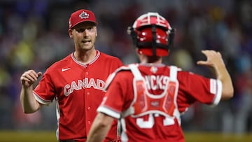 SAN JUAN, PUERTO RICO - MARCH 10: Brock Dykxhoorn #44 of Team Canada celebrates with Liam Hicks #34 after recording the last out of the 3-2 victory against Team Puerto Rico at Hiram Bithorn Stadium on March 10, 2026 in San Juan, Puerto Rico. Al Bello/Getty Images/AFP (Photo by AL BELLO / GETTY IMAGES NORTH AMERICA / Getty Images via AFP)