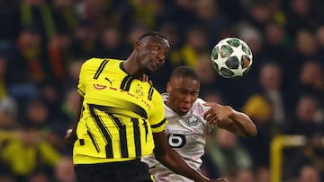 Soccer Football - Champions League - Round of 16 - First Leg - Borussia Dortmund v Lille - Signal Iduna Park, Dortmund, Germany - March 4, 2025 Borussia Dortmund's Serhou Guirassy in action with Lille's Bafode Diakite REUTERS/Thilo Schmuelgen