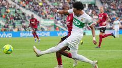 ELCHE, SPAIN - MARCH 19: Johan Mojica of Elche shoots under pressure from Dimitri Foulquier of Valencia CF during the LaLiga Santander match between Elche CF and Valencia CF at Estadio Manuel Martinez Valero on March 19, 2022 in Elche, Spain. (Photo by Ai