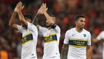 Soccer - Copa Libertadores - Group Stage - Group G - Athletico Paranaense v Boca Juniors - Arena da Baixada, Curitiba, Brazil - April 2, 2019 Boca Juniors' Carlos Tevez looks dejected after the match while Emmanuel Mas and Dario Benedetto applaud fans after the match REUTERS/Rodolfo Buhrer