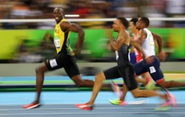 Photo for the ages | Bolt glances over at Andre De Grasse.