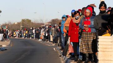 Commuters wait for the bus during a protest by taxi operators over the government&#039;s financial relief for the taxi industry, during the coronavirus lockdown, in Soweto, South Africa.