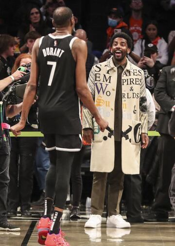 Mar 13, 2022; Brooklyn, New York, USA;  Brooklyn Nets guard Kyrie Irving (11) waits to greet Nets forward Kevin Durant (7) after the Nets defeated the New York Knicks at Barclays Center. Mandatory Credit: Wendell Cruz-USA TODAY Sports