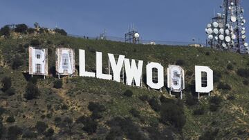 Banners, to read "Rams House", are installed over the Hollywood sign in Los Angeles, California, on February 14, 2022. - The temporary display will be installed to celebrate the Los Angeles Rams victory over the Cincinnati Bengals in Superbowl LVI on February 13. (Photo by Patrick T. FALLON / AFP)