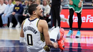 Tyrese Haliburton #0 of the Indiana Pacers grimaces after injuring his leg in the first half against the Boston Celtics.