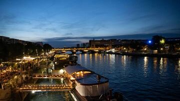 (FILES) Barge boats and restaurants line the Quai Francois Mauriac along the River Seine in Paris on July 22, 2023. The Adriana is the last of the 24 barges moored between the TrocadEro and the Bir-Hakeim bridge to be temporarily relocated to Boulogne-Billancourt and Saint-Cloud, to the west of the capital. All will be returned to their original locations the day after the opening ceremony on 26 July, 2024. (Photo by ALAIN JOCARD / AFP)