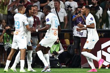 Marseille�s French midfielder #37 Emran Soglo (2nd L) celebrates with teammates after scoring the first goal for his team during the French L1 football match between FC Metz and Olympique Marseille (OM) at the Saint-Symphorien Stadium in Longeville-les-Metz, eastern France, on August 18, 2023. (Photo by SEBASTIEN BOZON / AFP)