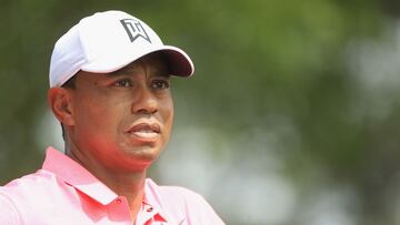 (FILES) US golfer Tiger Woods looks on during a practice round prior to the start of the 2018 Masters Tournament at Augusta National Golf Club in Augusta, Georgia, on April 2, 2018. Tiger Woods, a 15-time major winner who has not competed since the Masters following right ankle surgery, caddied for son Charlie in a 54-hole junior tournament, hinting at a possible December return. Woods has not announced a timetable for any comeback but handling his son's bags at the Notah Begay III Boys Junior Golf National Championship the weekend of November 4, 2023, in Louisiana indicated his body might nearly be ready for such a move. (Photo by Andrew Redington / GETTY IMAGES NORTH AMERICA / AFP)