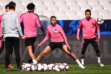 Paris Saint-Germain's French forward Kylian Mbappe and Paris Saint-Germain's Brazilian forward Neymar attend training.