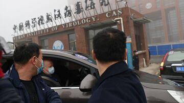 (FILES) In this file photo taken on February 03, 2021 members of the World Health Organization (WHO) team investigating the origins of the COVID-19 coronavirus arrive by car at the Wuhan Institute of Virology in Wuhan in China's central Hubei province on February 3, 2021. - An international expert mission to Wuhan has concluded that it was very likely that Covid first passed to humans from a bat through an intermediary animal, while all but ruling out a lab incident. The experts said that the intermediary host hypothesis was deemed "likely to very likely", while the theory that the virus escaped from a laboratory was seen as "extremely unlikely", according to the final version of the long-awaited report, of which AFP obtained a copy on March 29, 2021 before the official release. (Photo by HECTOR RETAMAL / AFP)