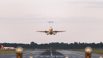 GATWICK AIRPORT, ENGLAND, UK – SEPTEMBER 13 2018: View directly down the runway as an easyJet Airlines plane takes off from Gatwick Airport with planes coming in to land behind it in the background.
