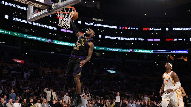 Jan 13, 2026; Los Angeles, California, USA; Los Angeles Lakers forward LeBron James (23) dunks the ball ahead of Atlanta Hawks forward Onyeka Okongwu (17) during the fourth quarter at Crypto.com Arena. Mandatory Credit: Kiyoshi Mio-Imagn Images