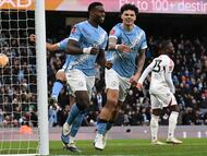 Manchester City's English defender #15 Marc Guehi (L) celebrates with Manchester City's English midfielder #33 Nico O'Reilly after scoring a goal during the English FA Cup third round football match between Manchester City and Salford City at the Etihad Stadium in Manchester, north west England, on February 14, 2026. (Photo by Oli SCARFF / AFP) / RESTRICTED TO EDITORIAL USE. No use with unauthorized audio, video, data, fixture lists, club/league logos or 'live' services. Online in-match use limited to 120 images. An additional 40 images may be used in extra time. No video emulation. Social media in-match use limited to 120 images. An additional 40 images may be used in extra time. No use in betting publications, games or single club/league/player publications. /