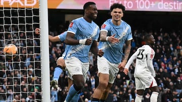 Manchester City's English defender #15 Marc Guehi (L) celebrates with Manchester City's English midfielder #33 Nico O'Reilly after scoring a goal during the English FA Cup third round football match between Manchester City and Salford City at the Etihad Stadium in Manchester, north west England, on February 14, 2026. (Photo by Oli SCARFF / AFP) / RESTRICTED TO EDITORIAL USE. No use with unauthorized audio, video, data, fixture lists, club/league logos or 'live' services. Online in-match use limited to 120 images. An additional 40 images may be used in extra time. No video emulation. Social media in-match use limited to 120 images. An additional 40 images may be used in extra time. No use in betting publications, games or single club/league/player publications. /