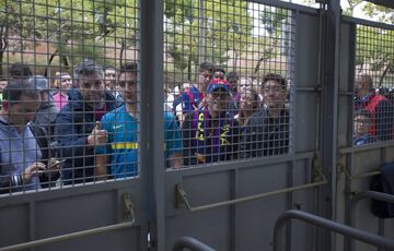 Un grupo de aficionados esperan en las puertas del recinto del Camp Nou.
