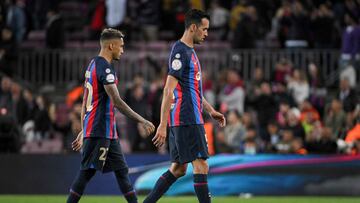 Barcelona's Brazilian forward Raphinha (L) and Barcelona's Spanish midfielder Sergio Busquets react at the end of the Copa del Rey (King's Cup) semi-final second leg football match between FC Barcelona and Real Madrid CF at the Camp Nou stadium in Barcelona on April 5, 2023. (Photo by LLUIS GENE / AFP)