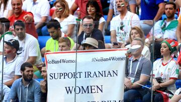 SAINT PETERSBURG, RUSSIA - JUNE 15: A woman holds up a large banner reading Support Iranian Women To Attend Stadiums, #NoBan4Women during the 2018 FIFA World Cup Russia group B match between Morocco and Iran at Saint Petersburg Stadium on June 15, 2018 in Saint Petersburg, Russia. (Photo by Simon Stacpoole/Offside/Getty Images)