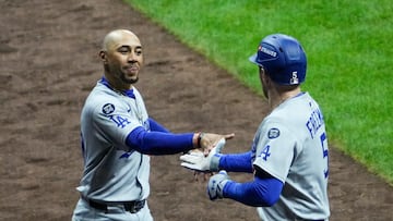 Oct 13, 2025; Milwaukee, Wisconsin, USA; Los Angeles Dodgers first baseman Freddie Freeman (5) celebrates after hitting a solo home run against the Milwaukee Brewers with shortstop Mookie Betts (50) in the sixth inning during game one of the NLCS round for the 2025 MLB playoffs at American Family Field. Mandatory Credit: Michael McLoone-Imagn Images