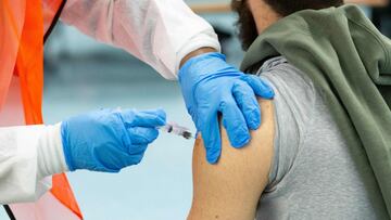 (FILES) In this file photo a man receives a dose of the Moderna coronavirus disease (COVID-19) vaccine at a vaccination site at South Bronx Educational Campus, in the Bronx New York on January 10, 2021. - The United States will hit President Joe Biden&#03