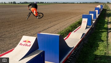 Dawid Godziek preforms backflip over train gap jump in Biala, Poland on August 25, 2024 during Red Bull Bike Express.