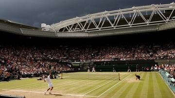 FILE PHOTO: Dark clouds drift over centre court during the finals match between Roger Federer of Switzerland and Rafael Nadal of Spain at the Wimbledon tennis championships in London July 6, 2008.   REUTERS/Kevin Lamarque/File Photo