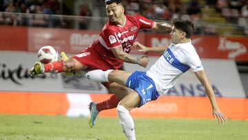 El jugador de Universidad Católica, Axel Cerda, disputa el balón con Lorenzo Reyes de Ñublense durante el partido por Primera Division.