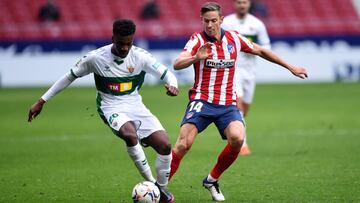 MADRID, SPAIN - DECEMBER 19: John Donald Okeh of Elche CF is challenged by Marcos Llorente of Atletico de Madrid during the La Liga Santander match between Atletico de Madrid and Elche CF at Estadio Wanda Metropolitano on December 19, 2020 in Madrid, Spa