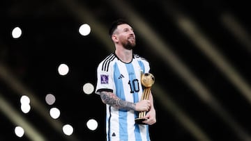 LUSAIL CITY, QATAR - DECEMBER 18: Lionel Messi of Argentina carries the 'Golden Ball' Player of the Tournament trophy during the FIFA World Cup Qatar 2022 Final match between Argentina and France at Lusail Stadium on December 18, 2022 in Lusail City, Qatar. (Photo by Alex Livesey - Danehouse/Getty Images)