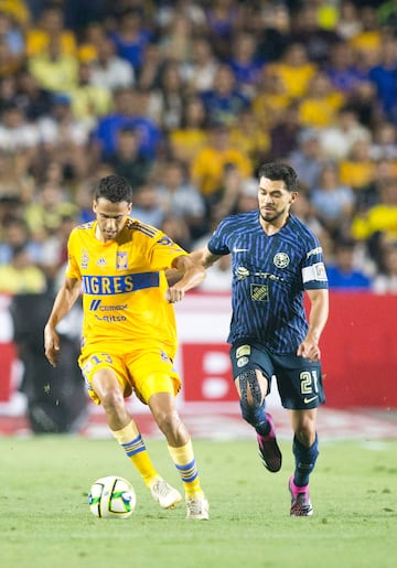 Tigres' Diego Reyes (L) vies for the ball with América's Henry Martín (R) during their Mexican Clausura 2023 match.