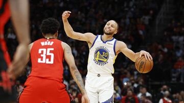 Jan 31, 2022; Houston, Texas, USA; Golden State Warriors guard Stephen Curry (30) dribbles the ball during the fourth quarter as Houston Rockets center Christian Wood (35) defends at Toyota Center. Mandatory Credit: Troy Taormina-USA TODAY Sports