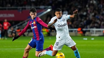 Barcelona's Spanish midfielder #08 Pedri fights for the ball with Girona's Brazilian forward #16 Savio Moreira during the Spanish league football match between FC Barcelona and Girona FC at the Estadi Olimpic Lluis Companys in Barcelona on December 10, 2023. (Photo by Pau BARRENA / AFP)