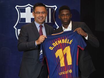 Barcelona's new player Ousmane Dembele (R) poses with his new jersey next to Barcelona's president Josep Maria Bartomeu at the Camp Nou stadium in Barcelona, during his official presentation at the Catalan football club, on August 28, 2017.
French starlet