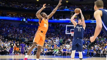 May 8, 2022; Dallas, Texas, USA; Dallas Mavericks guard Luka Doncic (77) makes a three point shot over Phoenix Suns center Bismack Biyombo (18) during the fourth quarter during game four of the second round for the 2022 NBA playoffs at American Airlines Center. Mandatory Credit: Jerome Miron-USA TODAY Sports