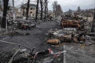 A civilian walks amid the destruction on a street in the town of Bucha.