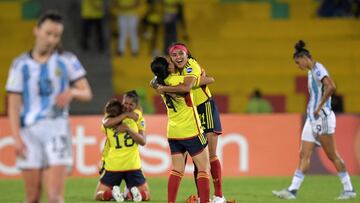 Colombian players Liana Salazar (R) and Diana Ospina celebrate at the end of the Conmebol 2022 women's Copa America football tournament semifinal match between Colombia and Argentina at the Alfonso Lopez stadium in Bucaramanga, Colombia, on July 25, 2022. (Photo by Raul ARBOLEDA / AFP)