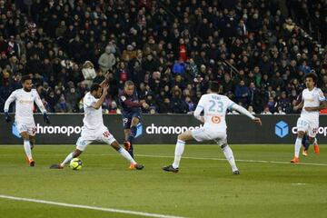 Paris Saint-Germain's French forward Kylian Mbappe shoots and scores despite Marseille's Rolando and Adil Rami's best attempts.