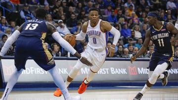 Jan 24, 2019; Oklahoma City, OK, USA; Oklahoma City Thunder guard Russell Westbrook (0) dribbles the ball between New Orleans Pelicans forward Cheick Diallo (13) and New Orleans Pelicans guard Jrue Holiday (11) during the second half at Chesapeake Energy Arena. Oklahoma City won 122-116. Mandatory Credit: Alonzo Adams-USA TODAY Sports