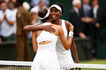 LONDON, ENGLAND - JULY 15: A victorious Garbine Muguruza of Spain is embraced by Venus Williams of The United States after the Ladies Singles final on day twelve of the Wimbledon Lawn Tennis Championships at the All England Lawn Tennis and Croquet Club at