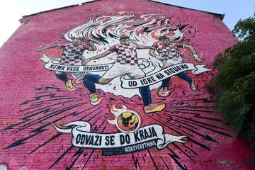 A picture shows a giant mural displaying the country's key footballers ; captain Luka Modric, former captain Darijo Srna and Mario Mandzukic in Zagreb, on July 9, 2018, ahead of the 2018 Russia World Cup semi-final football match between Crotia and Englan