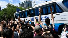 Fans of the Argentine national football team gesture towards a bus transporting members of the team during their arrival at the Four Seassons Hotel in Beijing on June 10, 2023. Argentina will play a friendly football match against Australia on June 15 at Beijing's newly-renovated 68,000-capacity Workers' Stadium. (Photo by Pedro PARDO / AFP)