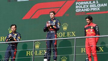 (LtoR) Red Bull Racing's Mexican driver Sergio Perez (runner-up), Red Bull Racing's Dutch driver Max Verstappen (winner) and Ferrari's Spanish driver Carlos Sainz Jr (third placed) celebrate during the podium ceremony of the Belgian Formula One Grand Prix at Spa-Francophones racetrack at Spa, on August 28, 2022. (Photo by JOHN THYS / AFP)