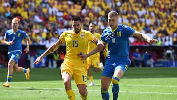 Soccer Football - Euro 2024 - Group E - Romania v Ukraine - Munich Football Arena, Munich, Germany - June 17, 2024 Romania's Andrei Burca in action with Ukraine's Artem Dovbyk REUTERS/Angelika Warmuth