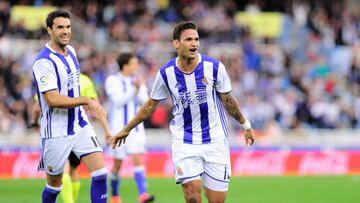 Real Sociedad's Brazilian forward Willian Jose (R) celebrates after scoring his team's second goal during the Spanish league football match Real Sociedad vs Valencia CF at the Anoeta stadium in San Sebastian on December 10, 2016. / AFP PHOTO / ANDER GILLENEA